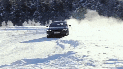 Black car racing in snow.