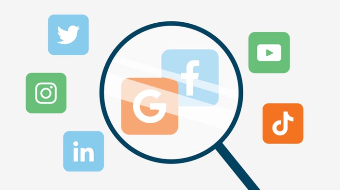 An image of a magnifying glass and various popular social media platforms.