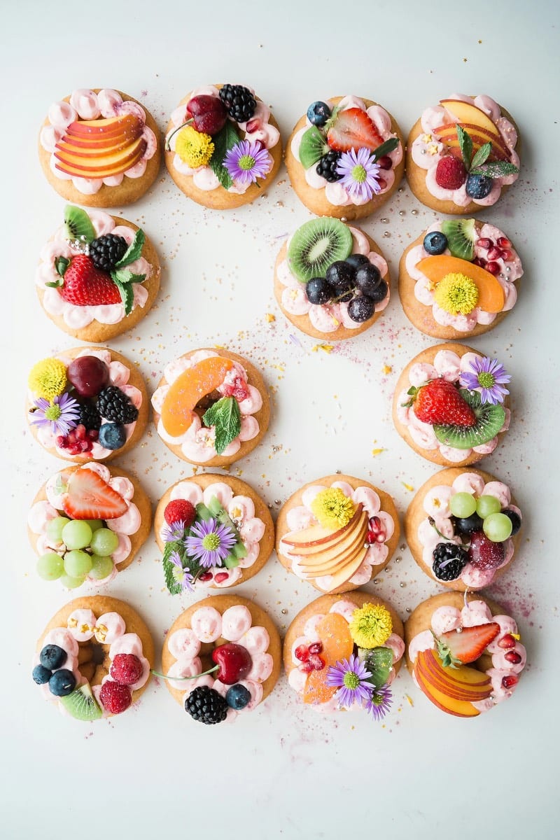 delicious appetizers of fruit and cream on top of cupcakes